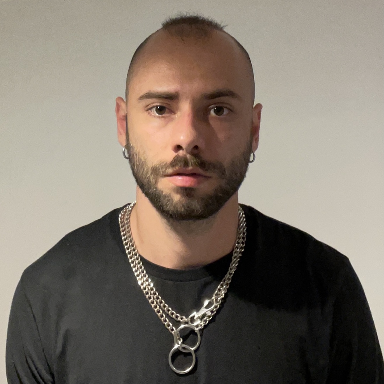 person with black t shirt and necklace 